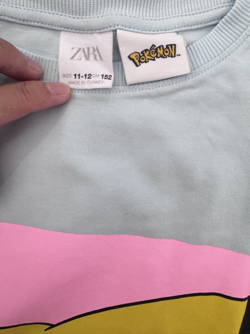 Zara Pokemon Pikachu T-shirt (Category: Babies & Kids Fashion) located in Cabanatuan. Submitted by thearchivemuse (Listing ID 1435365072, Image 2). Description: - Zara Pikachu T-shirt - Light blue color - Features a Pikachu design with a pink square background - Size: 11-12 (152cm) - Made in Turkey.