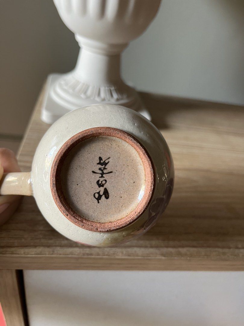 Japanese Floral Stoneware tea cup (Category: Coffee & Tea Tableware) located in Quezon City. Submitted by metamerchant (Listing ID 1437068966, Image 3). Description: - size: diameter 7.5cm x height 6.5cm - Pink, purple, and yellow design - Comfortable handle - Unique shape - Features Japanese characters - Perfect for hot beverages - Great gift idea.
