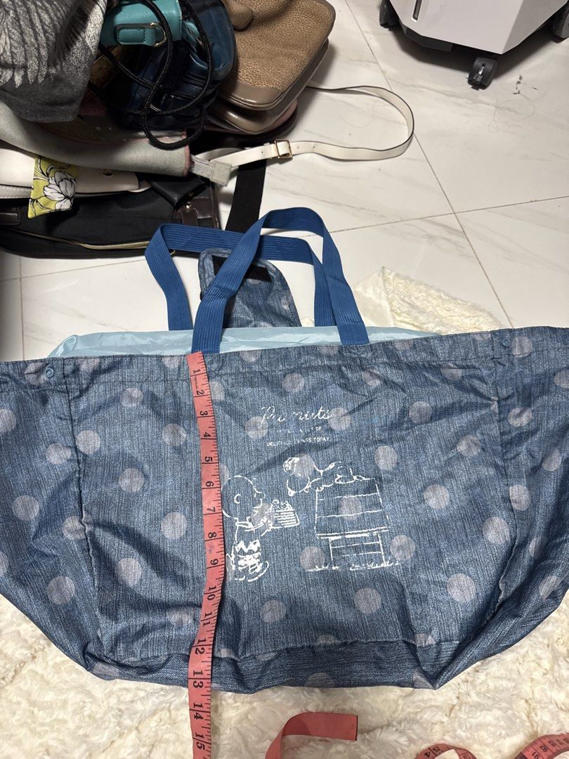 2027 Big Snoopy Polka Dot Tote Bag (Category: Tote Bags) located in Silang. Submitted by sari2bilina (Listing ID 1437041687, Image 1). Description: - Snoopy design with polka dots - Blue handles - Drawstring closure - Dimensions: Approximately 28" width x 10" height - Small front pocket - Light blue interior.