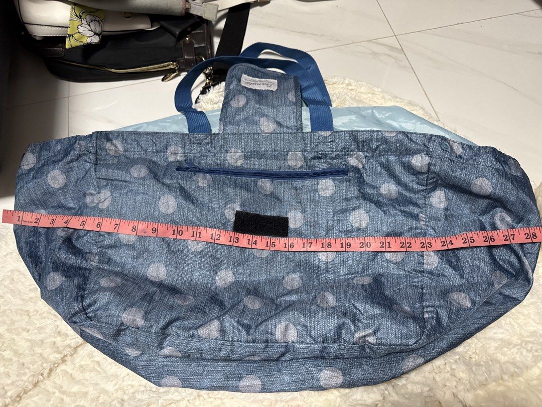 2027 Big Snoopy Polka Dot Tote Bag (Category: Tote Bags) located in Silang. Submitted by sari2bilina (Listing ID 1437041687, Image 2). Description: - Snoopy design with polka dots - Blue handles - Drawstring closure - Dimensions: Approximately 28" width x 10" height - Small front pocket - Light blue interior.