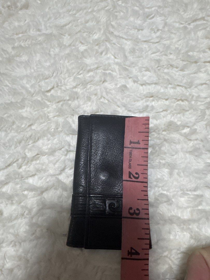 2027 Pierre Cardin Black Key Holder (Category: Accessory Holder, Box & Organizers) located in Silang. Submitted by sari2bilina (Listing ID 1437032774, Image 2). Description: - Black key holder - Snap closure - Gold-colored interior - Includes key rings - Decorative band with logo - Dimensions: 4 inches (closed), 6 inches (open).