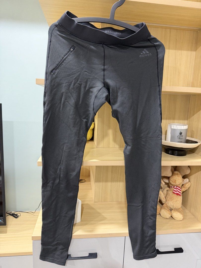Adidas Running Leggings (Category: Activewear) located in Mandaluyong City. Submitted by jpc0708 (Listing ID 1437135001, Image 1). Description: - Adidas running leggings - Dark grey color - Zippered side pocket - Ankle zippers - "ADIDAS RUNNING" printed waistband - Textured, striped pattern - Length: Approximately 36 inches.
