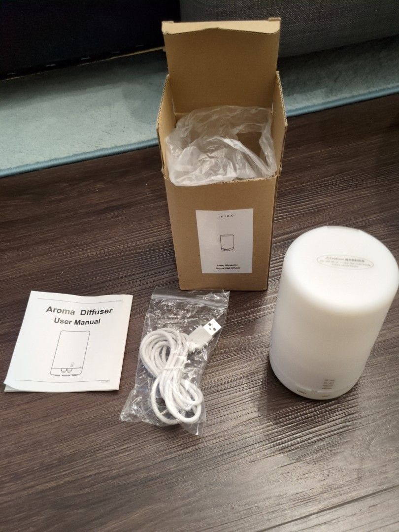 Aroma Diffuser (Category: Home Fragrance) located in Singapore. Submitted by bewtan (Listing ID 1437153703, Image 2). Description: - Iuiga aroma mist diffuser - White, cylindrical design - Includes original packaging - Comes with USB cable - User manual included - Ideal for home or office use - Creates a relaxing environment.