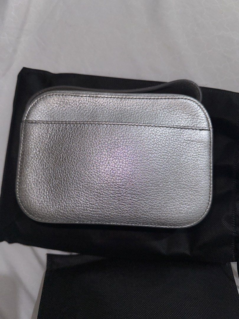 Balenciaga Metallic Silver Camera Bag (Category: Luxury Bags & Wallets) located in Quezon City. Submitted by jdmc16 (Listing ID 1437145586, Image 3). Description: - Metallic silver Balenciaga handbag - Includes a wrist strap - Detachable shoulder strap included - Features the Balenciaga logo - Comes with a dust bag - Made of leather with a textured finish.