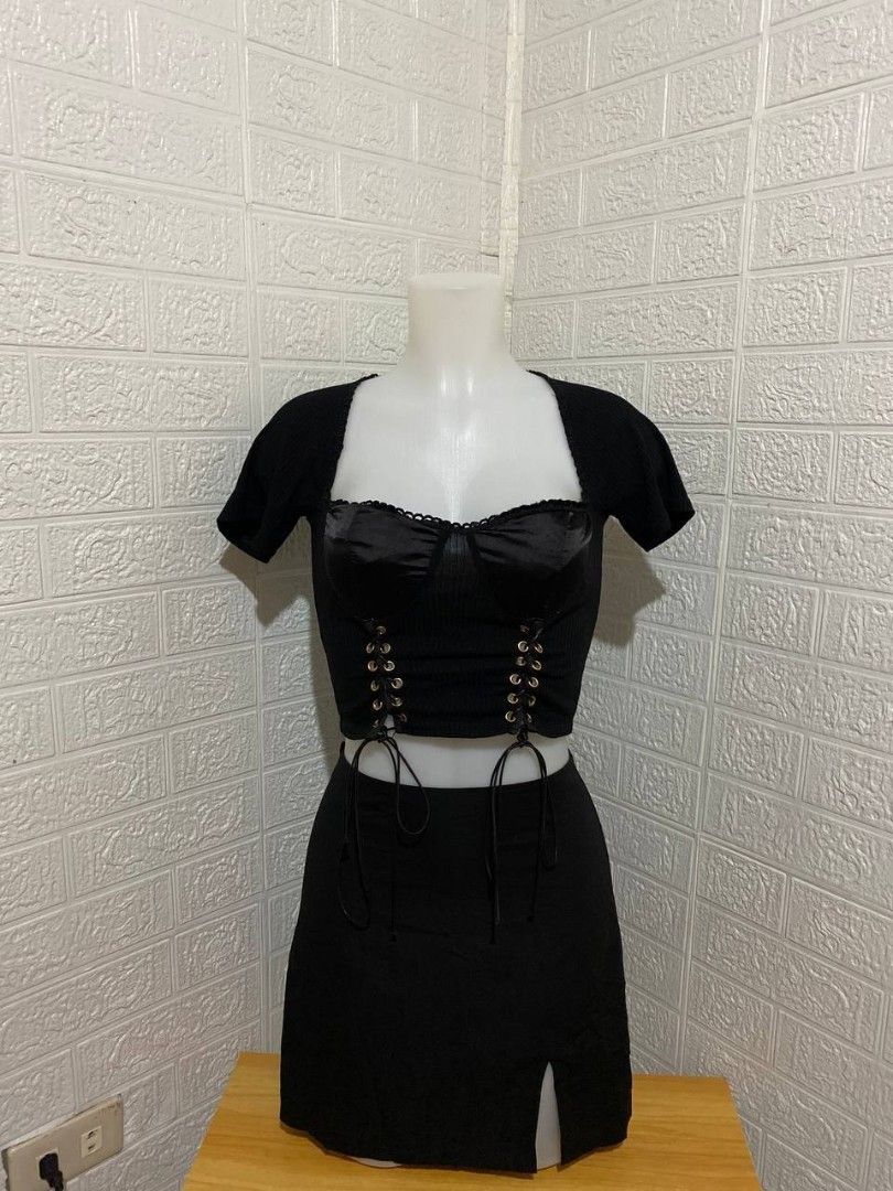 Black Corset Top and Mini Skirt Set (Category: Sets or Coordinates) located in Manila. Submitted by leshmode_ig (Listing ID 1437162946, Image 1). Description: - Black two-piece set - Corset top with satin-like bust and lace-up detail - Mini skirt with side slit - Perfect for special occasions or a night out - Made of smooth, likely synthetic fabric.