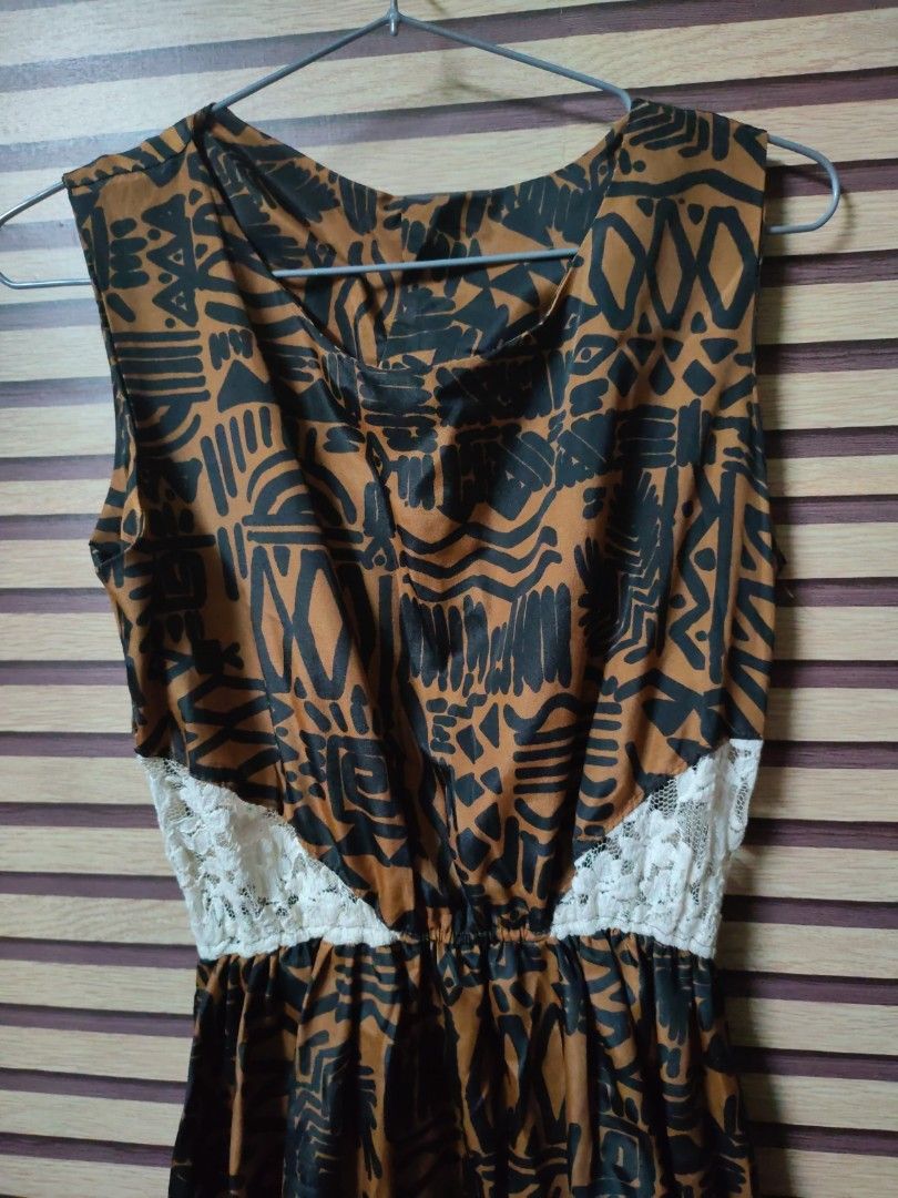 Brown and Black Patterned Dress with Lace (Category: Dresses) located in Makati City. Submitted by mybentables (Listing ID 1437152278, Image 2). Description: - Brown and black patterned dress - Sleeveless design - Fitted waist with white lace detail - Made of lightweight fabric - Perfect for warm weather - Can be dressed up or down -Tagged as free size because no size label on the dress when bought but can fit small to medium.