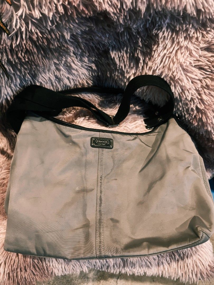 Coach Shoulder Bag (Category: Luxury Bags & Wallets) located in Taguig. Submitted by wear.us.ph (Listing ID 1437133794, Image 1). Description: - Coach shoulder bag - Neutral color - Black strap - Zippered pocket at the back - Small logo on the front - Made in China - Nylon-like material need wash..