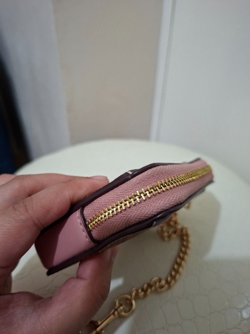Coach Zip CC S/G Card Holder pink (Category: Luxury Bags & Wallets) located in Paranaque City. Submitted by potatoiceblended (Listing ID 1425920142, Image 3). Description: Coach card holder with a zip closure. Features a signature Coach print with pink accents and a gold chain. Includes card slots and a zip compartment. The tag indicates the style is IM/TAN/PINK PETAL. Made in Cambodia. authentic. i can provide receipt..