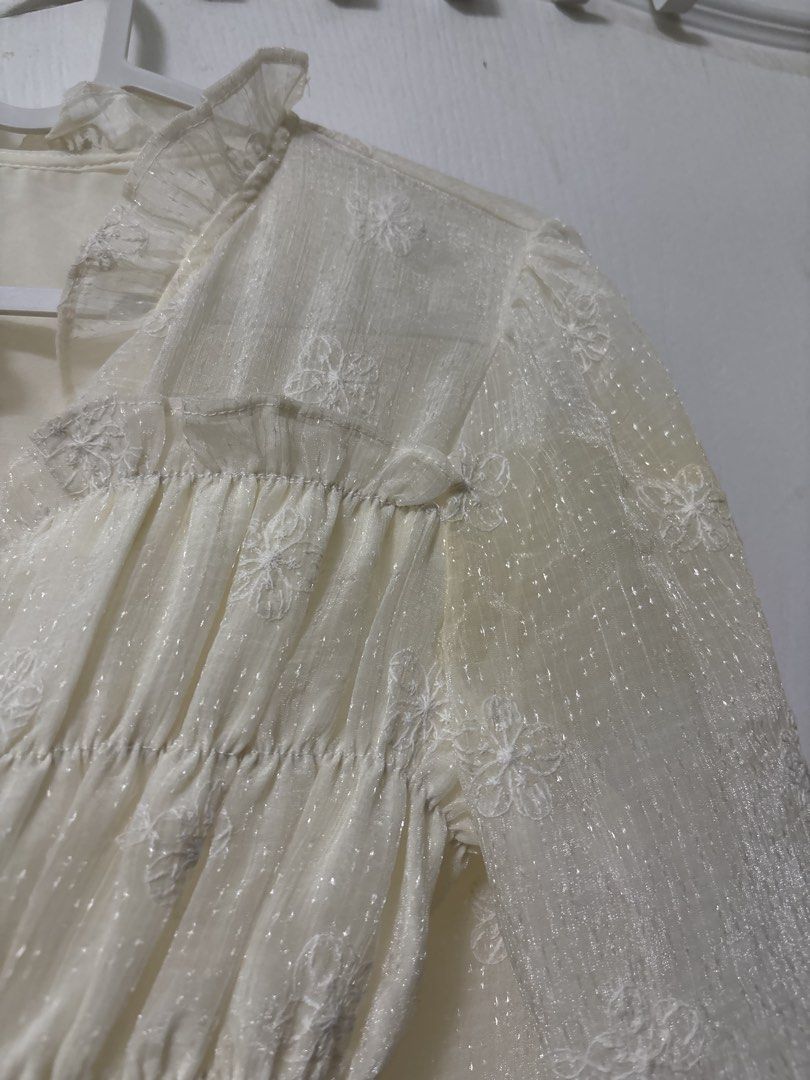 Cream Floral Embroidered Blouse (Category: Blouses) located in Manila. Submitted by kykynsss (Listing ID 1437054232, Image 2). Description: Preloved Fits SMALL -MEDIUM For courier pick up only at Brgy La Paz Makati City - Cream-colored blouse - Floral embroidery - Long sleeves - Ruffled collar - Button-down front with pearl-like buttons - Visible stain on sleeve - Lined.