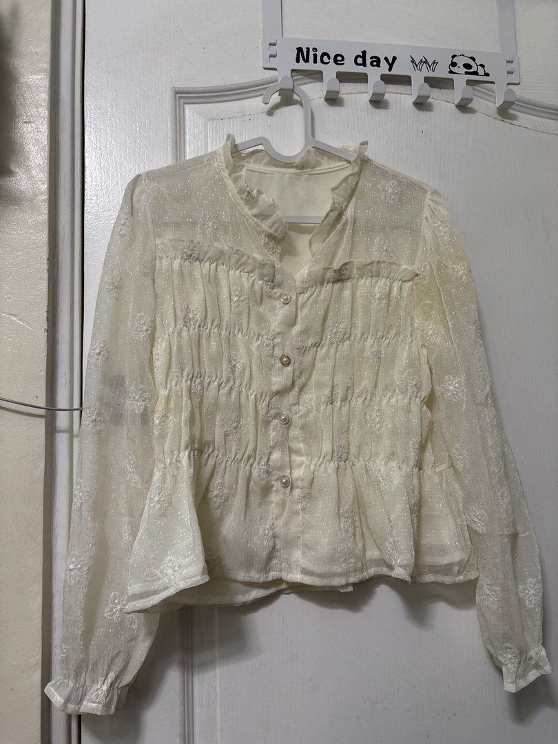 Cream Floral Embroidered Blouse (Category: Blouses) located in Manila. Submitted by kykynsss (Listing ID 1437054232, Image 1). Description: Preloved Fits SMALL -MEDIUM For courier pick up only at Brgy La Paz Makati City - Cream-colored blouse - Floral embroidery - Long sleeves - Ruffled collar - Button-down front with pearl-like buttons - Visible stain on sleeve - Lined.