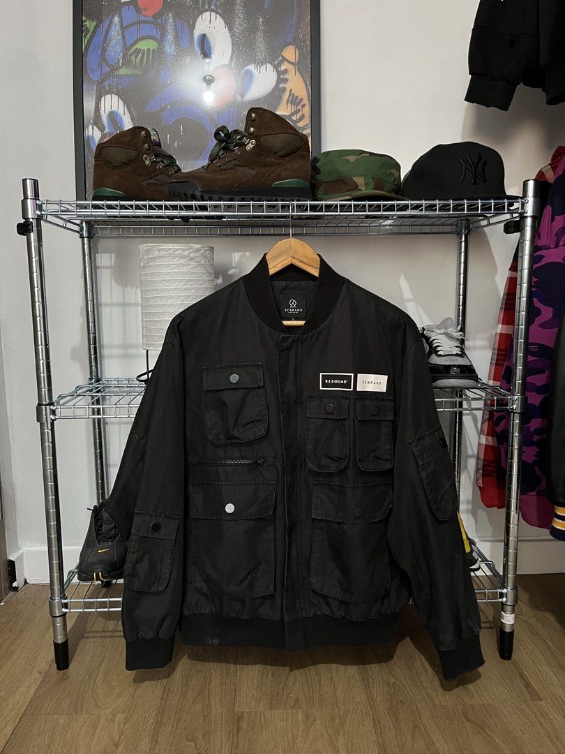DeBrand Resquad Black Bomber Jacket (Category: Coats, Jackets and Outerwear) located in Pasay City. Submitted by synag (Listing ID 1437205209, Image 1). Description: DeBrand black bomber jacket. Size L. Features multiple pockets, ribbed collar/cuffs, and a "RESQUAD" patch. Classic bomber style. 22x25.5 .