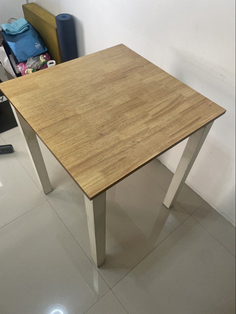 Dining Table (2 seater) (Category: Tables & Sets) located in Quezon City. Submitted by alex_bhc (Listing ID 1437077520, Image 2). Description: Selling used 2-seater dining table with visible signs of wear. No defects (hindi umuuga, no uneven legs). White legs and light-wash wood top. Price slightly negotiable, shipping care of buyer. Dimension: 60 cm*60 cm.