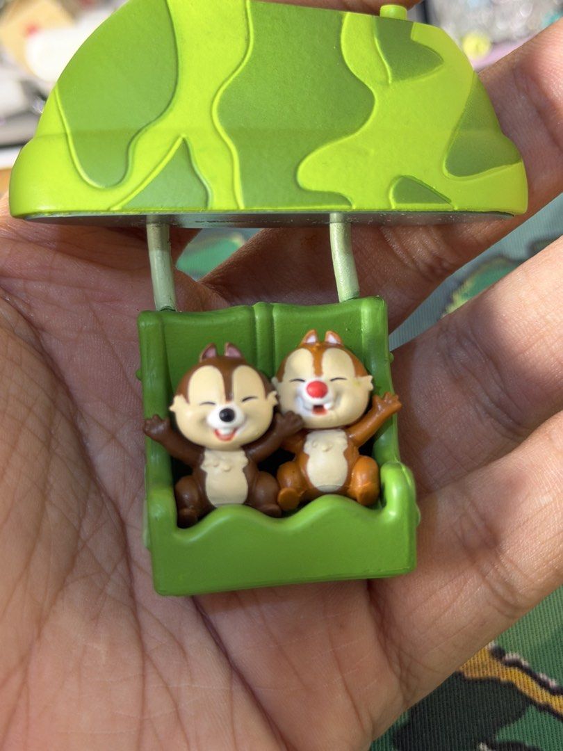 Disney Chip and Dale Figurine (Category: Figurines & Statues) located in Baguio. Submitted by jonathanseller_buyer (Listing ID 1437020202, Image 3). Description: - Adorable Chip and Dale figurine - Features Chip and Dale in a hot air balloon-like structure - Chip and Dale are seated with arms open - Green seat and camouflage pattern on top - Detailed design and vibrant colors.