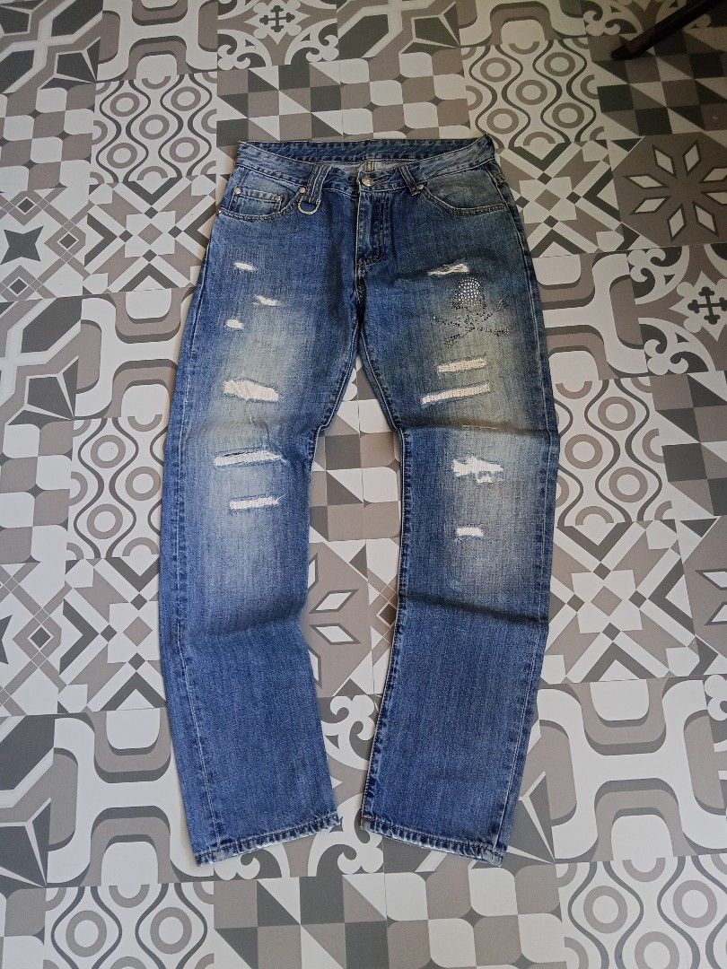 Distressed Jeans with Skull Detail (Category: Jeans) located in Manila. Submitted by rahzzelula73279 (Listing ID 1437194893, Image 1). Description: - Distressed jeans with skull and crossbones rhinestone design. - Classic five-pocket design. - Button closure with decorative ring. - Medium wash. - Relaxed fit. - Leather patch on back pockets. SIZE 32 BIDS LNG MINIMAL ISSUE .