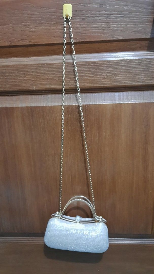 Elegant Clutch Bag with Chain Strap (Category: Clutches) located in Pasig City. Submitted by decluterringformentalhealth (Listing ID 1437198660, Image 3). Description: - Champagne-gold shimmering exterior - Gold-toned handle - Black fabric lining - Secure clasp closure - Never been used - Ideal for special events.