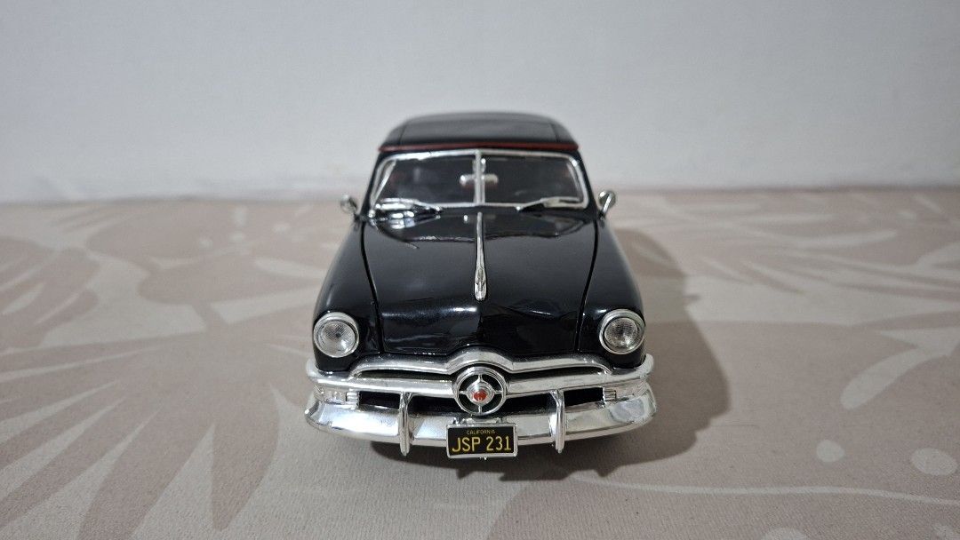 Ford 1950 Convertible Diecast Model, 1/18 scale (Category: Vehicle & Diecast Models) located in Imus. Submitted by pick_and_dig (Listing ID 1437201382, Image 3). Description: This is a 1:18 scale diecast model of a 1950 Ford Convertible by Maisto, featuring a black finish and functional parts. Model Details: The model is highly detailed with over 130 parts, including rubber tires and a detailed engine bay. Functional Features: It includes openabl