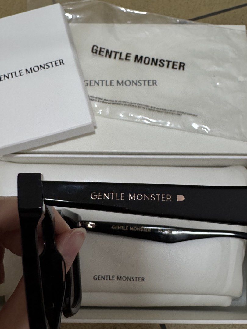 Gentle Monster Her.s-01 Sunglasses (Category: Sunglasses & Eyewear) located in Quezon City. Submitted by ekacloset (Listing ID 1437139886, Image 2). Description: - Authentic Gentle Monster Flatba Her sunglasses - Color: Black - Includes: - Original box - Case - Authenticity card - Cleaning cloth - Gentle Monster logo visible on temples and case.