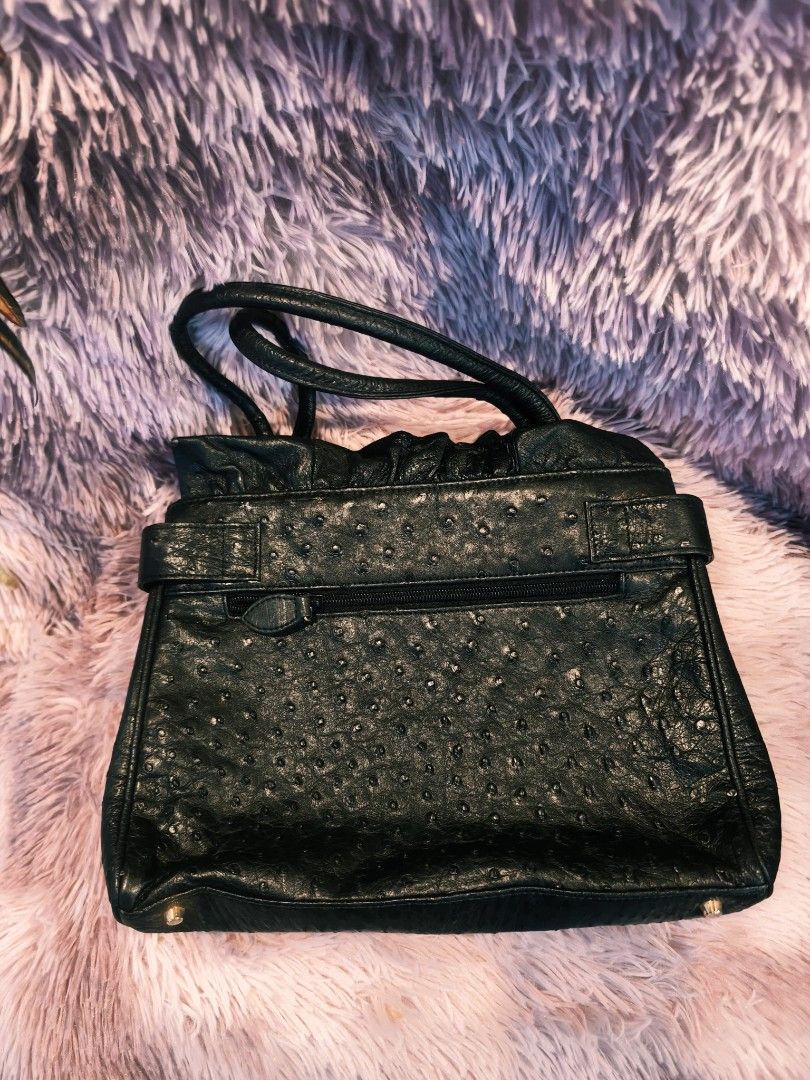 Genuine Ostrich Leather Handbag (Category: Luxury Bags & Wallets) located in Taguig. Submitted by wear.us.ph (Listing ID 1437135326, Image 2). Description: - Genuine ostrich leather handbag - Classic black color - Top handle design - Secure buckle closure - Textured finish - Gold-toned hardware - Includes brand tag - Interior zipper pocket.