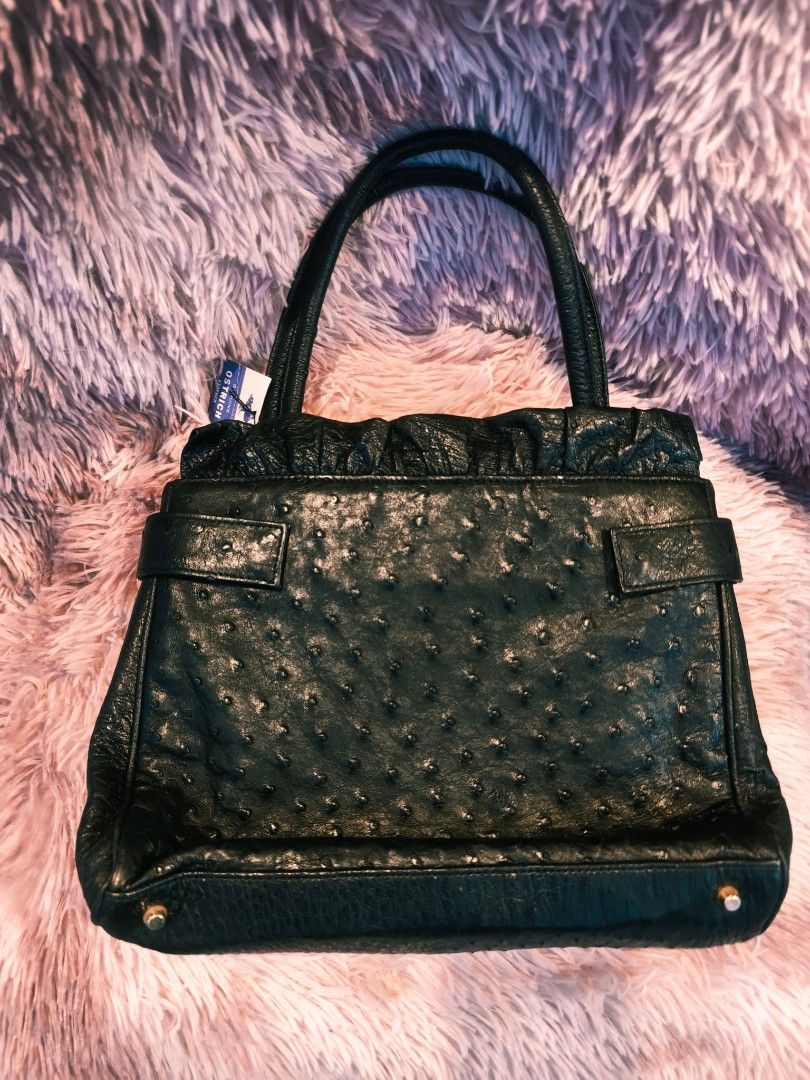 Genuine Ostrich Leather Handbag (Category: Luxury Bags & Wallets) located in Taguig. Submitted by wear.us.ph (Listing ID 1437135326, Image 1). Description: - Genuine ostrich leather handbag - Classic black color - Top handle design - Secure buckle closure - Textured finish - Gold-toned hardware - Includes brand tag - Interior zipper pocket.