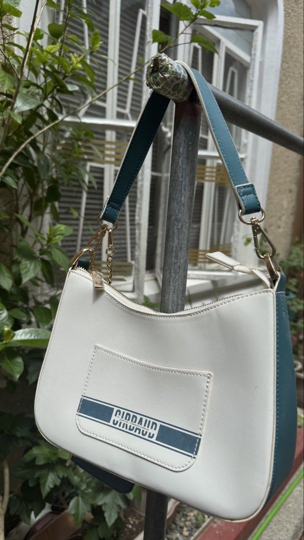 Girbaud Shoulder Bag with Card Holder (Category: Luxury Bags & Wallets) located in Manila. Submitted by lovejas.mnl (Listing ID 1437032390, Image 1). Description: - Girbaud shoulder bag - White body with teal accents - Gold chain detail - Zipper closure - Includes detachable card holder - Ideal for everyday use.