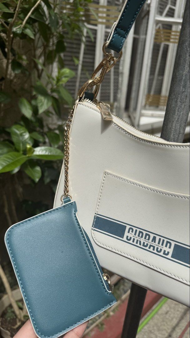 Girbaud Shoulder Bag with Card Holder (Category: Luxury Bags & Wallets) located in Manila. Submitted by lovejas.mnl (Listing ID 1437032390, Image 2). Description: - Girbaud shoulder bag - White body with teal accents - Gold chain detail - Zipper closure - Includes detachable card holder - Ideal for everyday use.