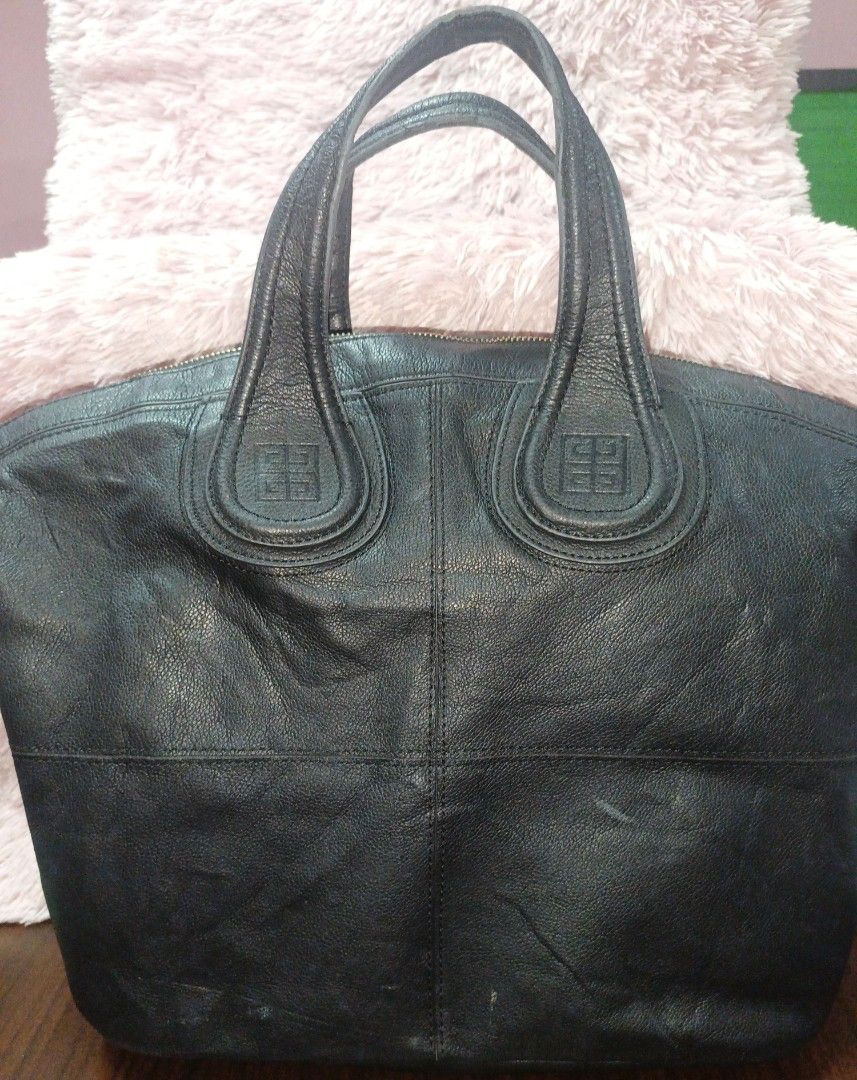 Givenchy Black Leather Handbag (Category: Luxury Bags & Wallets) located in Rizal. Submitted by judithtillo19 (Listing ID 1437143392, Image 2). Description: - Givenchy black leather handbag - Top handle design - Embossed logo detail - Gold-toned zipper closure - Made in Italy - Textured leather finish - Spacious interior NOTE: PRELOVED BUT IN GOOD CONDITION NO SLING INCLUDED CLEAN ( NEW SPA) 12"X16"X6".