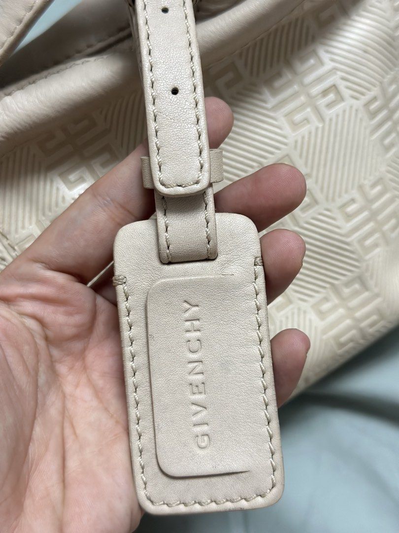 Givenchy kili kili Shoulder Bag (Category: Luxury Bags & Wallets) located in Quezon City. Submitted by mema0522 (Listing ID 1437145012, Image 2). Description: - Givenchy shoulder bag - Light beige color - Repeating pattern design - Zipper closure - Single shoulder strap - Gold-toned hardware - Includes leather Givenchy logo tag.