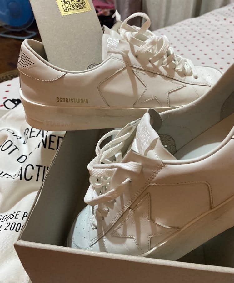 Golden Goose Stardan Sneakers (Category: Sneakers) located in Zamboanga. Submitted by sherwinrh (Listing ID 1437162990, Image 2). Description: - Golden Goose Stardan sneakers - White colorway - Star design on the side - Brand name detail on the side - Comes with original box, dust bag, and tags - Includes Golden Goose passport - Classic low-top design - White laces - NFC 👍.