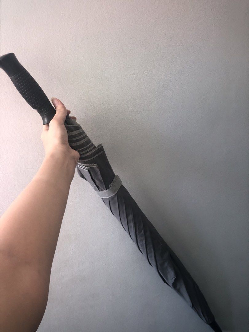 Golf Umbrella (Category: Umbrellas) located in Makati City. Submitted by danittt (Listing ID 1437056756, Image 1). Description: - Dark grey canopy - Black handle with textured grip - Light grey interior with 'South Gate' print - Includes a strap for secure closure Big umbrella type Bought this for 1k Selling for only 580.