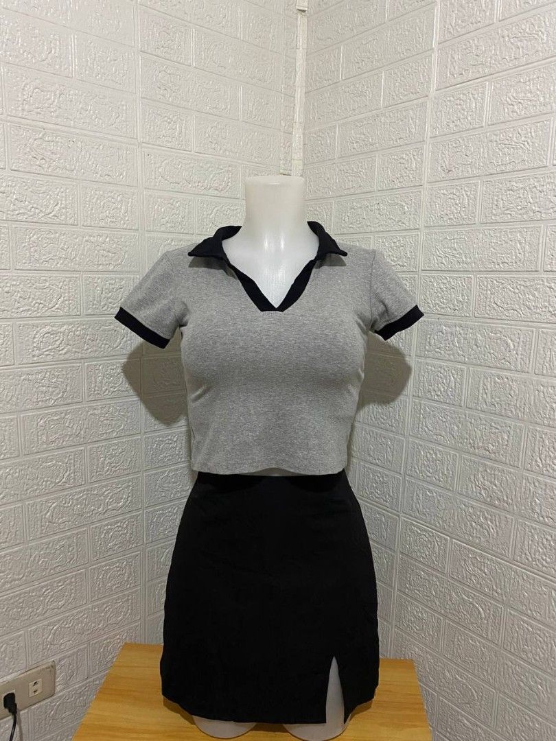 Grey Crop Top and Black Skirt Set (Category: Sets or Coordinates) located in Manila. Submitted by leshmode_ig (Listing ID 1437162949, Image 1). Description: - Two-piece outfit - Grey crop top with black collar and trim - Black mini skirt with side slit - Suitable for casual wear or nights out - Fitted top - Skirt sits at the waist - Mix and match potential.