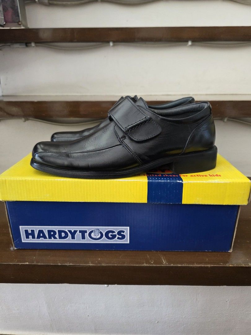 HardyTogs Black Velcro Shoes (Category: Babies & Kids Fashion) located in Quezon City. Submitted by trey_21 (Listing ID 1437019191, Image 2). Description: - Like new Black HardyTogs shoes (used only twice during gala school event) - Features velcro straps for easy wear - Includes original yellow and blue box - Shoes appear unworn - Classic design, versatile for any occasion - Size 23cm insole - Call or text 09175997226.