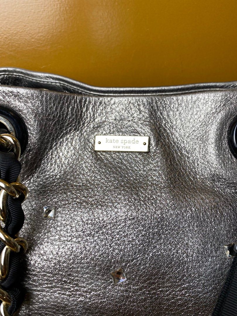 Kate Spade Metallic Gray/Silver Big Bow Tote (Category: Luxury Bags & Wallets) located in Taytay. Submitted by thepearllabph (Listing ID 1437143365, Image 3). Description: KATE SPADE Metallic Pebbled Leather Chain Tote Handbag Price: 4,000php Stunning and flashy. Hard to come by . Unique with durable leather. Nice black bow and ribbon chain. *Appearance 8.5/10 Color: Silver Model/Circa: Material: leather Pattern: plain Size: large Origin: Lining: