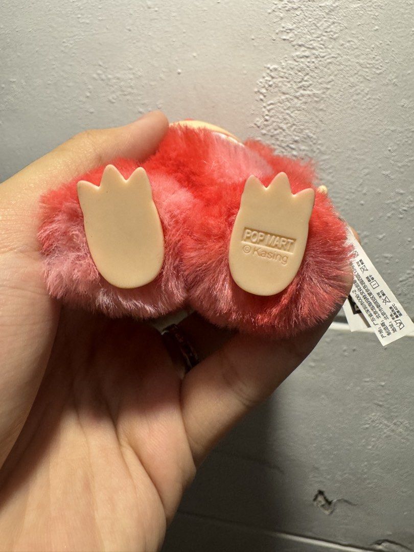 Labubu Love (Category: Toys & Games) located in Manila. Submitted by migss__ (Listing ID 1437170924, Image 2). Description: - POP MART Kasing Monster plush figure - Vibrant red and pink colors - Soft, furry exterior - Smiling face with visible teeth - Small arms and feet - POP MART and Kasing branding on feet - Collectible item.
