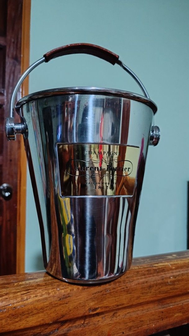 Laurent-Perrier Champagne Ice Bucket (Category: Other Kitchenware & Tableware) located in Taguig. Submitted by redarmy21775000 (Listing ID 1437154527, Image 1). Description: - Laurent-Perrier ice bucket - Stainless steel body - Brown leather handle with embossed brand name - Gold-colored label - Perfect for champagne and other beverages - Classic design.