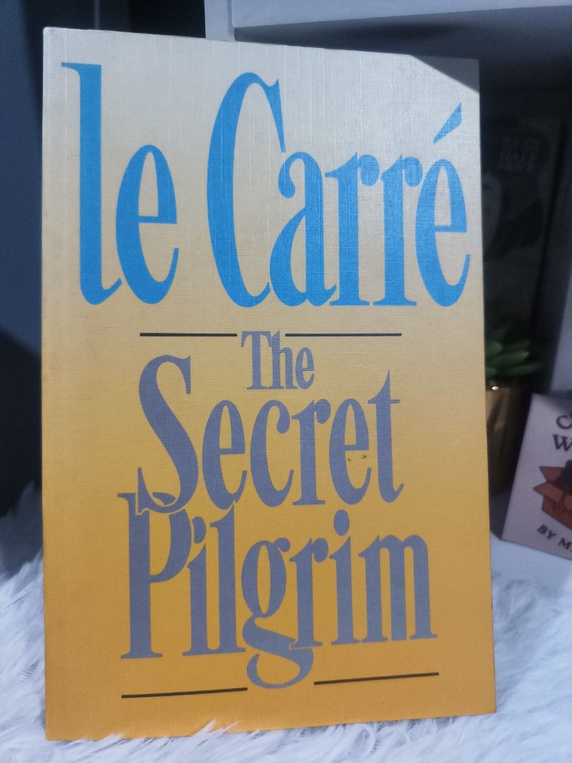 Le Carré The Secret Pilgrim (Category: Storybooks) located in Cabuyao City. Submitted by chaptersandwonders143 (Listing ID 1437117098, Image 1). Description: - John le Carré's 'The Secret Pilgrim' for sale. - English edition. - Pages are intact and readable. - Cover design: Yellow and gold gradient with blue and grey lettering..