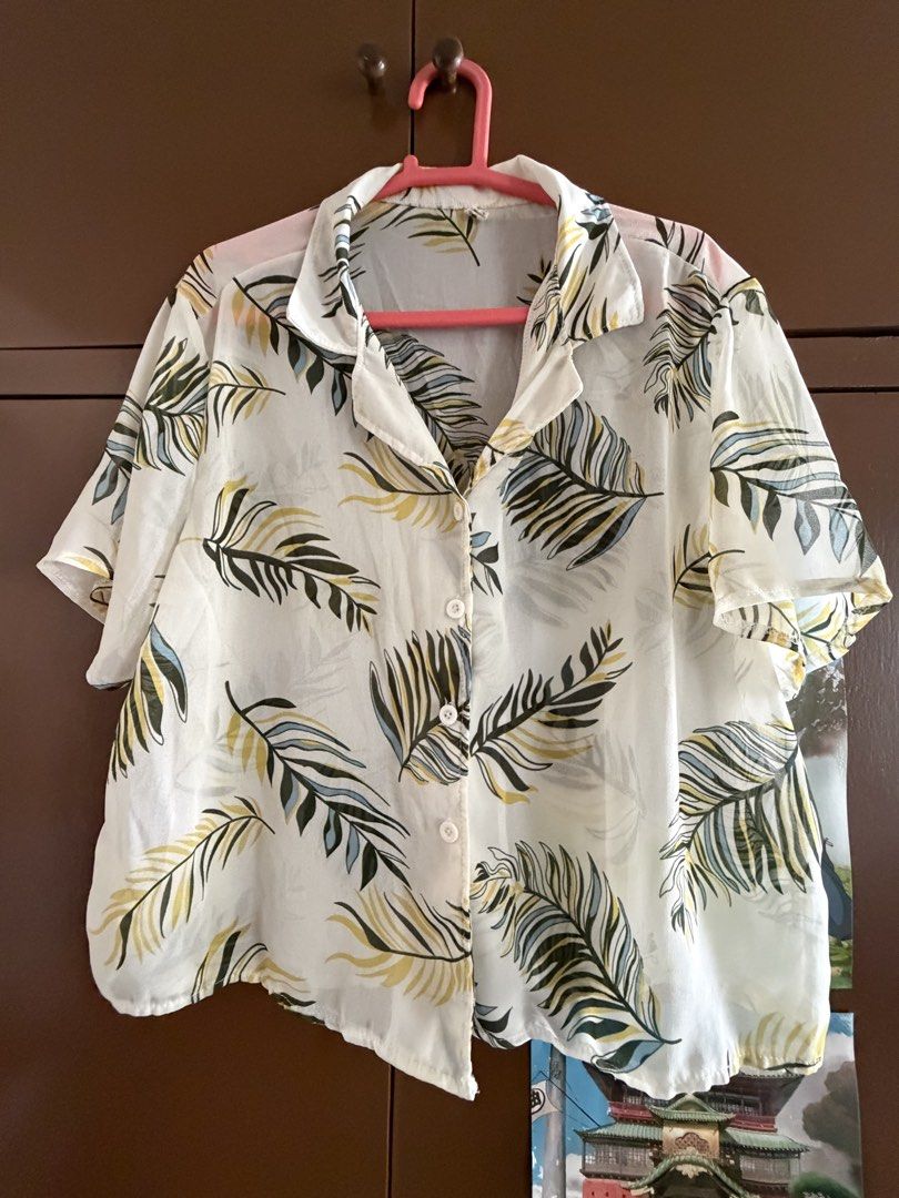 Leaf Print Button-Down Blouse (Category: Blouses) located in Pasig City. Submitted by abibilitinda (Listing ID 1437086568, Image 1). Description: - Floral print button-down blouse - Short sleeves - Collared neckline - Lightweight material - Relaxed fit - Perfect for warm weather - Versatile: Wear buttoned up or open as a layering piece.