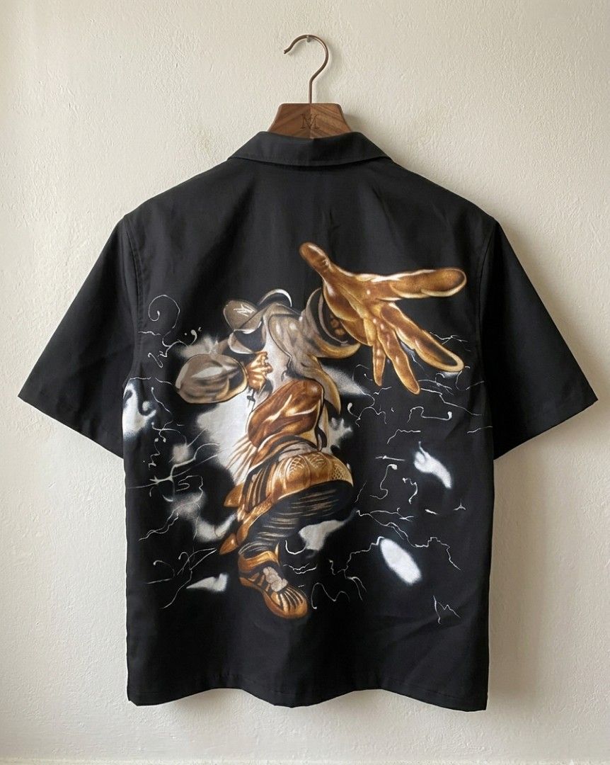 Limp Bizkit Graphic Polo Vintage-style short-sleeved (Category: Tshirts & Polo Shirts ) located in Baguio. Submitted by luxeloom099 (Listing ID 1437158201, Image 2). Description: Limp Bizkit Graphic Polo Vintage-style short-sleeved button-up with a bold Y2K/Nu-Metal aesthetic. Features striking front and back graphics of a stylized urban figure with oversized golden hands and sneakers, accented by lightning-style artwork. Made from smooth black p