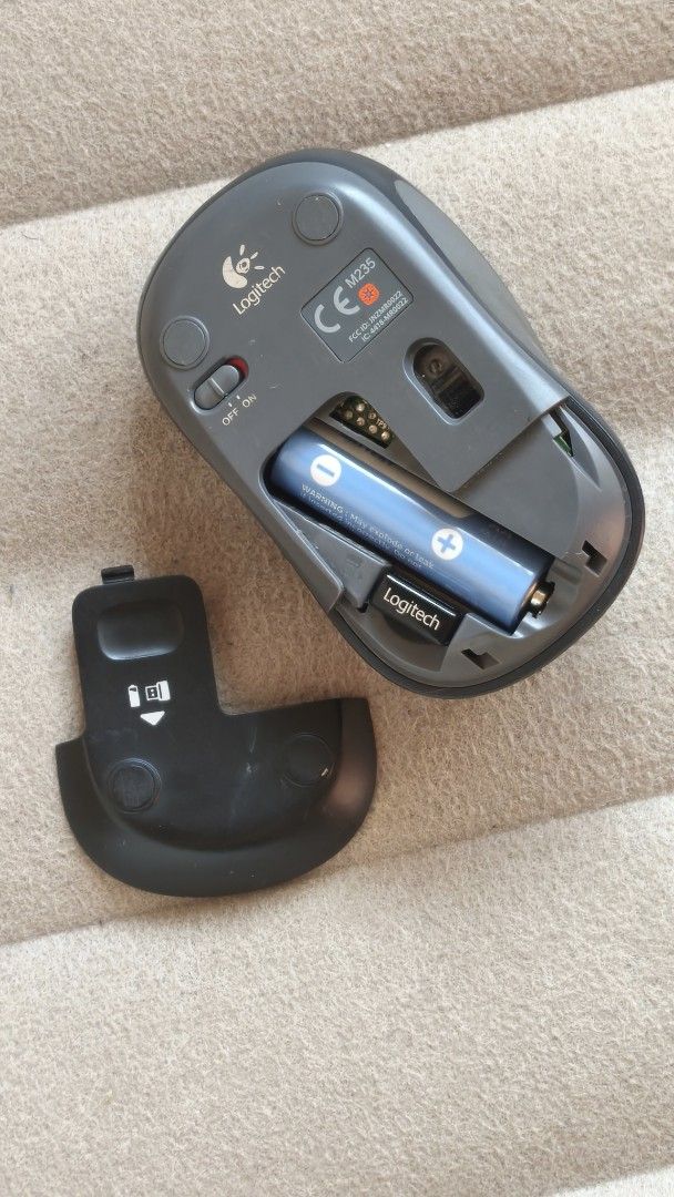 Logitech Wireless Mouse (Category: Mouse & Mousepads) located in Kuala Lumpur. Submitted by leovoyager (Listing ID 1437019164, Image 2). Description: - Logitech M185 wireless mouse - Color: Blue and Black - Includes one AA battery - Features: - Scroll wheel - Two buttons - Power on/off switch - Battery compartment cover included.