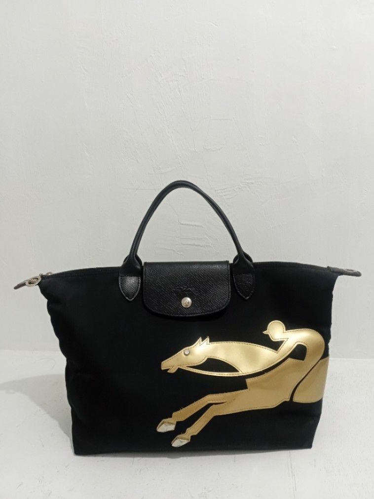 Longchamp Le Pliage Handbag with Horse Design (Category: Luxury Bags & Wallets) located in Navotas City. Submitted by riyuwi (Listing ID 1436931610, Image 3). Description: -PreOwnedWellUsed Authentic Limited Edition Longchamp Le Pliage Yr of the horse black handbag - Gold horse design - Top handle - Flap closure - Zipper closure Ykk Zip - Interior lining with brand logo pattern, Small leather logo ,& jellytag both intact on lining inside of the b