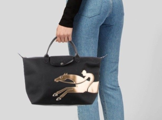 Longchamp Le Pliage Handbag with Horse Design (Category: Luxury Bags & Wallets) located in Navotas City. Submitted by riyuwi (Listing ID 1436931610, Image 2). Description: -PreOwnedWellUsed Authentic Limited Edition Longchamp Le Pliage Yr of the horse black handbag - Gold horse design - Top handle - Flap closure - Zipper closure Ykk Zip - Interior lining with brand logo pattern, Small leather logo ,& jellytag both intact on lining inside of the b