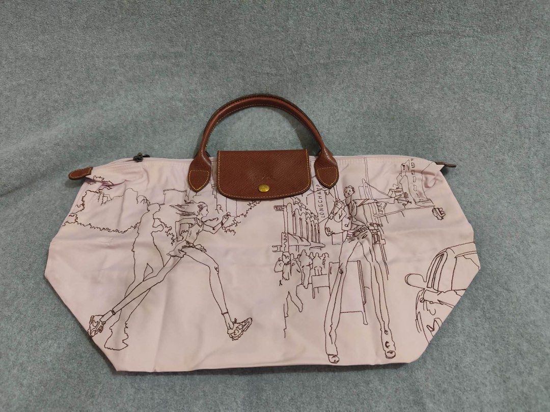 Longchamp Limited Ed. Bandee Dessinee Medium Short Handle (Category: Luxury Bags & Wallets) located in Quezon City. Submitted by venchar (Listing ID 1437209902, Image 1). Description: - Authentic Longchamp Le Pliage handbag - Unique design with old rose body and black outline illustration - Brown leather handles and flap closure - Gold-colored button detail - Secure zipper closure - Foldable design for easy storage - brand new - never been use.