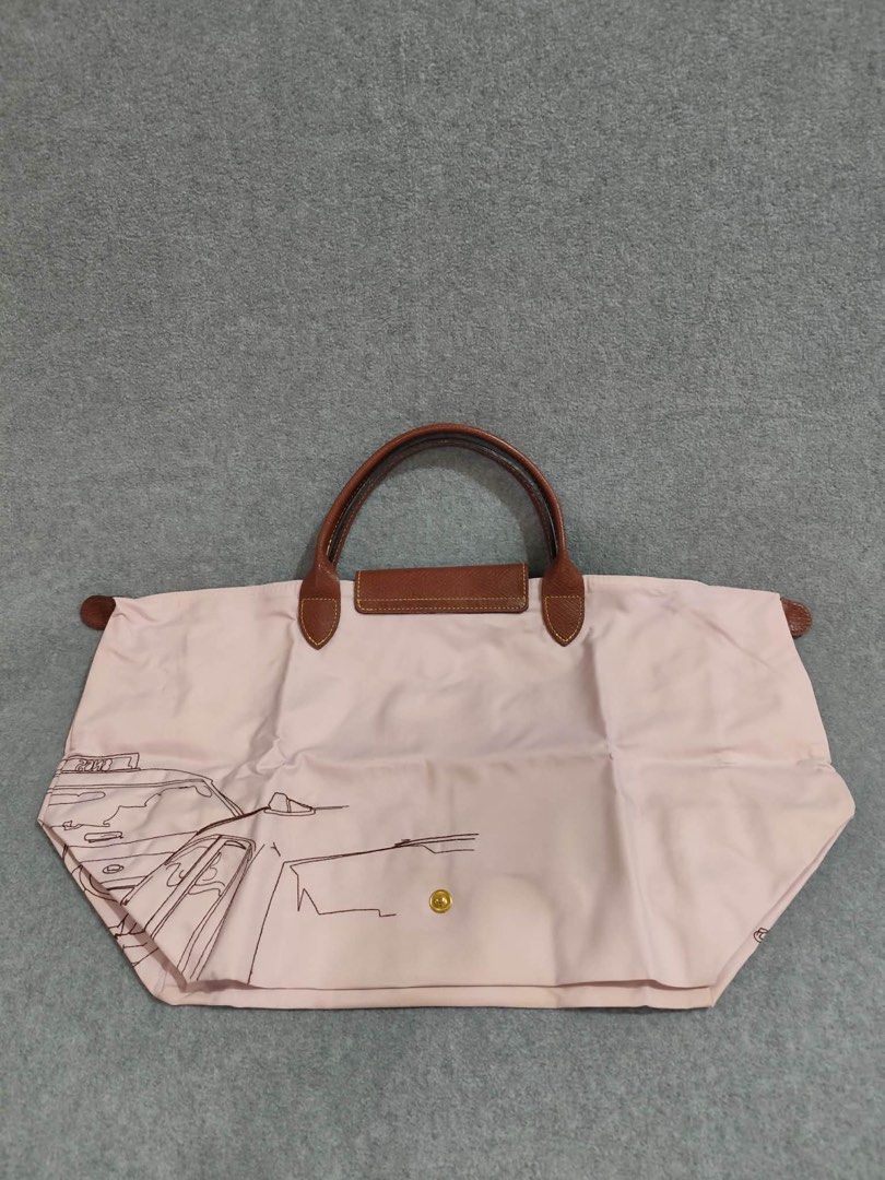 Longchamp Limited Ed. Bandee Dessinee Medium Short Handle (Category: Luxury Bags & Wallets) located in Quezon City. Submitted by venchar (Listing ID 1437209902, Image 2). Description: - Authentic Longchamp Le Pliage handbag - Unique design with old rose body and black outline illustration - Brown leather handles and flap closure - Gold-colored button detail - Secure zipper closure - Foldable design for easy storage - brand new - never been use.