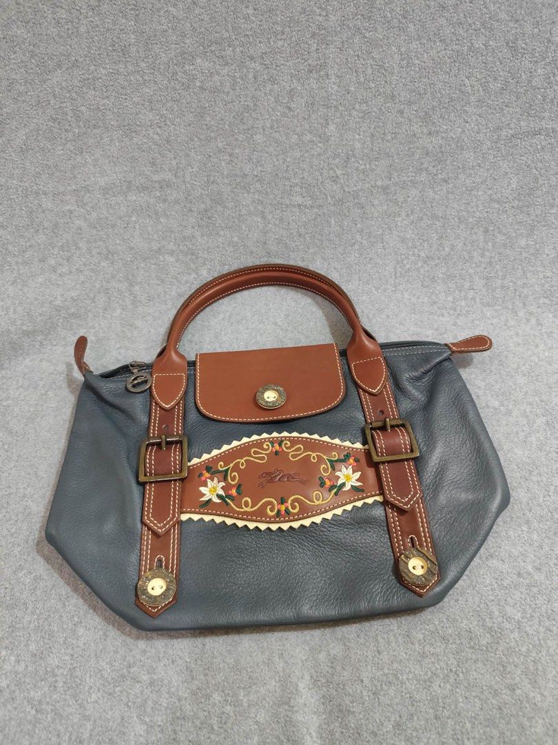 Longchamp Limited Ed. Bavaria Short Handle (Category: Luxury Bags & Wallets) located in Quezon City. Submitted by venchar (Listing ID 1437209497, Image 3). Description: - Authentic Limited Edition Longchamp handbag - Unique design with decorative embroidery - Stylish gray body with brown leather accents - Convenient top handle - Secure flap closure with button - Features a zipper closure with Longchamp logo on the pull - brand new - never been us
