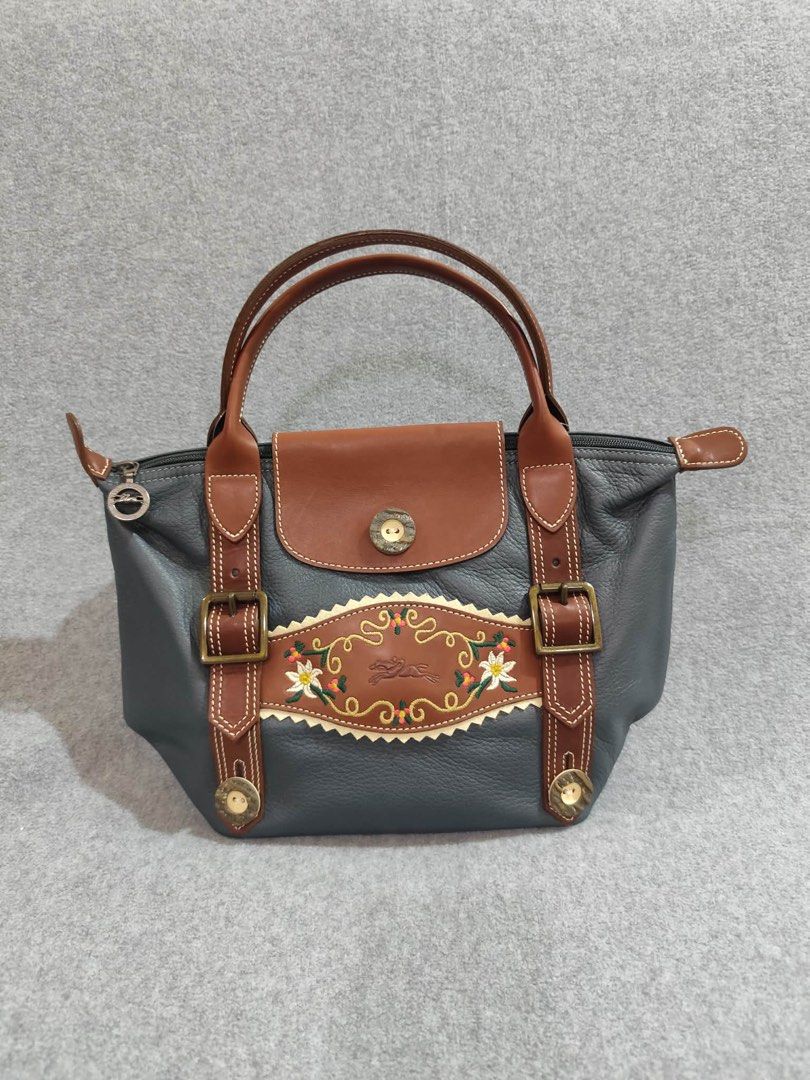 Longchamp Limited Ed. Bavaria Short Handle (Category: Luxury Bags & Wallets) located in Quezon City. Submitted by venchar (Listing ID 1437209497, Image 1). Description: - Authentic Limited Edition Longchamp handbag - Unique design with decorative embroidery - Stylish gray body with brown leather accents - Convenient top handle - Secure flap closure with button - Features a zipper closure with Longchamp logo on the pull - brand new - never been us