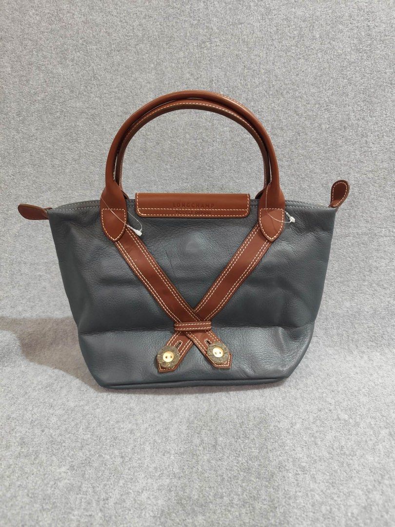 Longchamp Limited Ed. Bavaria Short Handle (Category: Luxury Bags & Wallets) located in Quezon City. Submitted by venchar (Listing ID 1437209497, Image 2). Description: - Authentic Limited Edition Longchamp handbag - Unique design with decorative embroidery - Stylish gray body with brown leather accents - Convenient top handle - Secure flap closure with button - Features a zipper closure with Longchamp logo on the pull - brand new - never been us