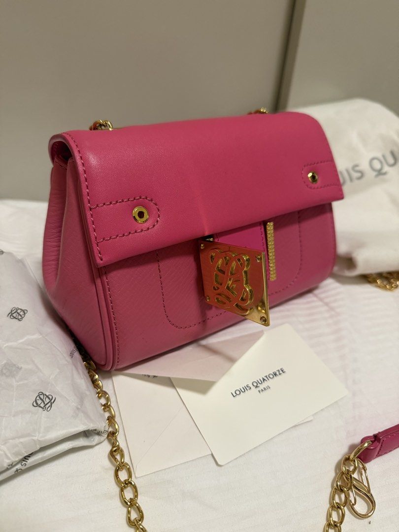 Louis Quatorze Pink Shoulder Bag (Category: Shoulder Bags) located in Tarlac. Submitted by never.wearing (Listing ID 1437125144, Image 2). Description: - Authentic Louis Quatorze shoulder bag - Vibrant pink color - Gold chain strap - Gold-tone clasp with logo - Includes dust bag and card - Lined interior with small pocket.