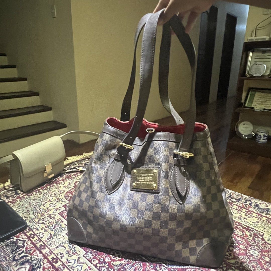 Louis Vuitton Damier (Category: Luxury Bags & Wallets) located in Cagayan de Oro. Submitted by chandythegreat (Listing ID 1437149038, Image 2). Description: This is a pre-owned Louis Vuitton Damier Ebene Hampstead MM tote bag featuring a checkered brown canvas body, brown leather straps, and a gold-tone "Louis Vuitton Inventeur" plaque on the front. 100% Original bought it around 70k selling it for 40k No issue minimal sign of use only super kapa