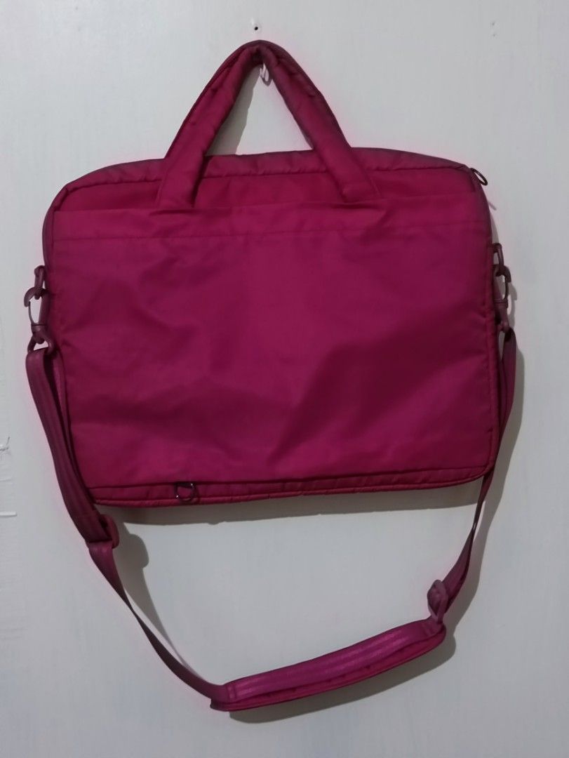 Laptop Bag with Shoulder Strap (Category: Laptop Bags & Sleeves) located in Manila. Submitted by greatbrandsforless (Listing ID 1437029834, Image 2). Description: - Pink laptop bag - Top handle and detachable shoulder strap - Front pocket - Zipper closure - Durable, possibly water-resistant material - Suitable for laptops and essentials - Solid color, simple design.