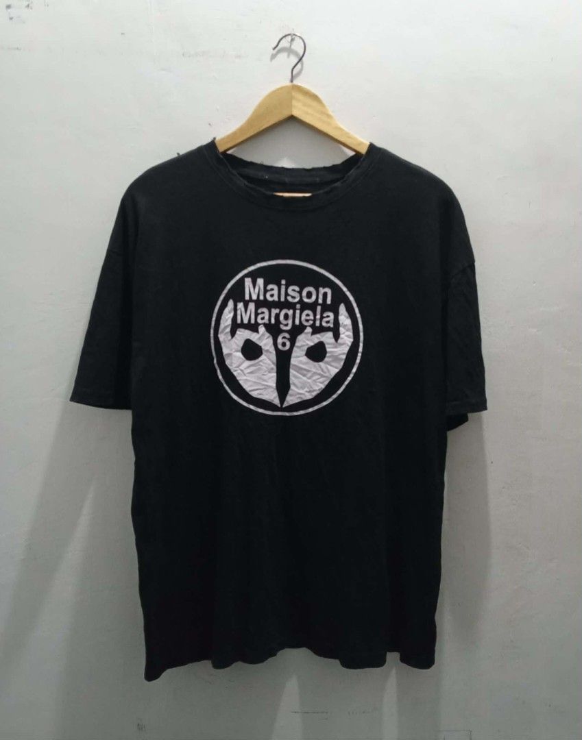 Maison Margiela 6 Graphic Tee (Category: Luxury Apparel) located in Navotas City. Submitted by ms.soulana (Listing ID 1437164425, Image 1). Description: PreOwned WellUsed Maison Margiela 6 graphic Printed t-shirt black Large -XL Width 23.5" -24" X L29" - Features a white circle graphic with the brand name and the number '6' - Classic crew neck design - Short sleeves - Made from cotton fabric Off/Legit. Cut tags Sign of Wear Good Condition 8.9/10 