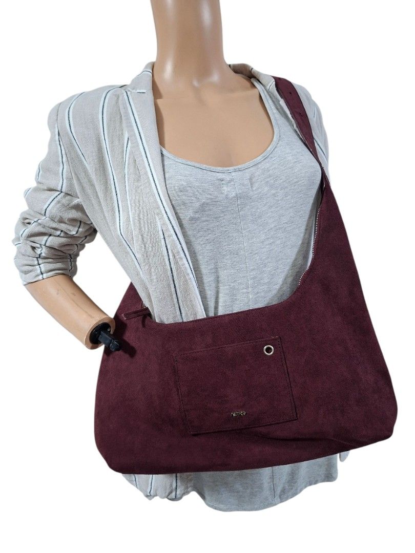 Maroon Shoulder Bag with Pocket (Category: Shoulder Bags) located in Rizal. Submitted by KCS0001 (Listing ID 1437071446, Image 1). Description: - Medium size - Maroon shoulder bag - Single front pocket - Long strap for over-the-shoulder wear - Simple, rounded design - Made of soft, textured material - Shown on a mannequin.